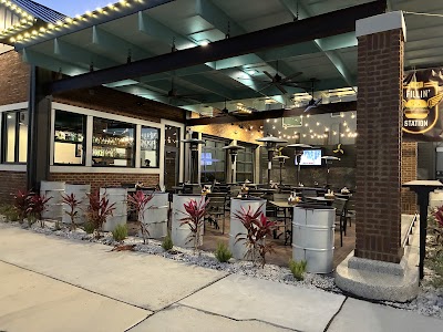 The Fillin' Station's covered patio and brick exterior, lit with string lights, in downtown Palatka